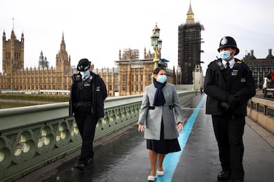 Britain's Secretary of State of the Home Department Priti Patel wears a mask as she crosses the Westminster Bridge, in London, Britain, January 18, 2021. REUTERS/Hannah McKay