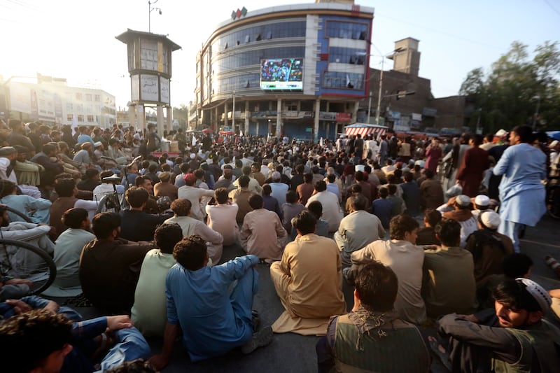 Fans gather to cheer on their side in Jalalabad, with the match being held in Trinidad. AP