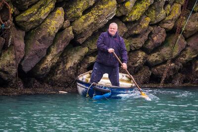 epa08881429 A man paddles a small boat in the harbour in Folkestone, Kent, Britain, 13 December 2020. EU Commission President, Ursula von der Leyen and British Prime Minister Boris Johnson have announced on 13 December that they have mandated negotiators to continue Brexit talks to see if an agreement can be reached.  EPA/VICKIE FLORES