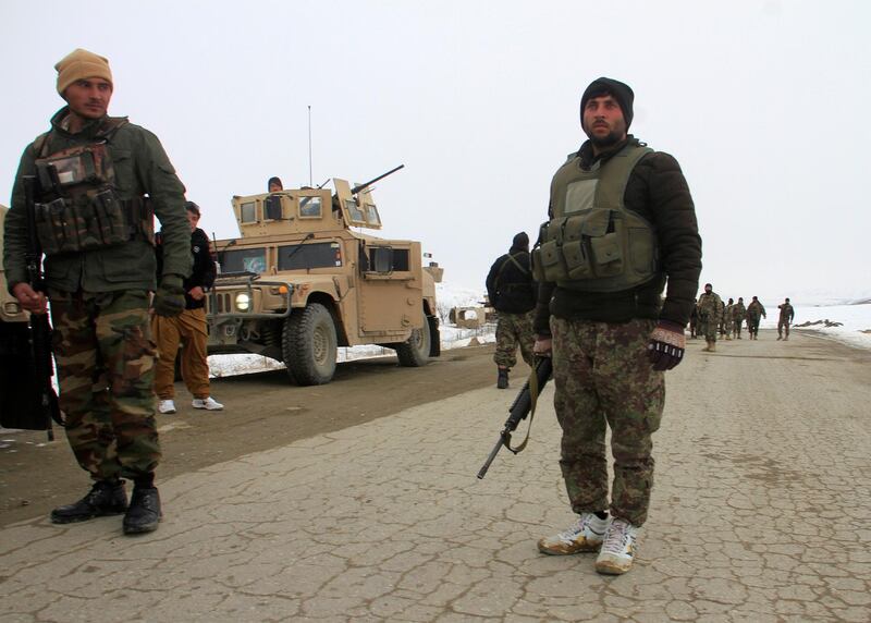 Afghan National Army forces go towards the site of an airplane crash in Deh Yak district of Ghazni province. Reuters