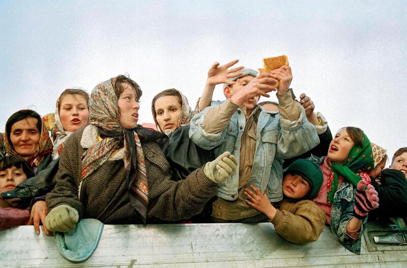 Refugees evacuated from the besieged Muslim enclave of Srebrenica struggle for bread on their arrival in Tuzla, Bosnia on March 29, 1993. AP Photo