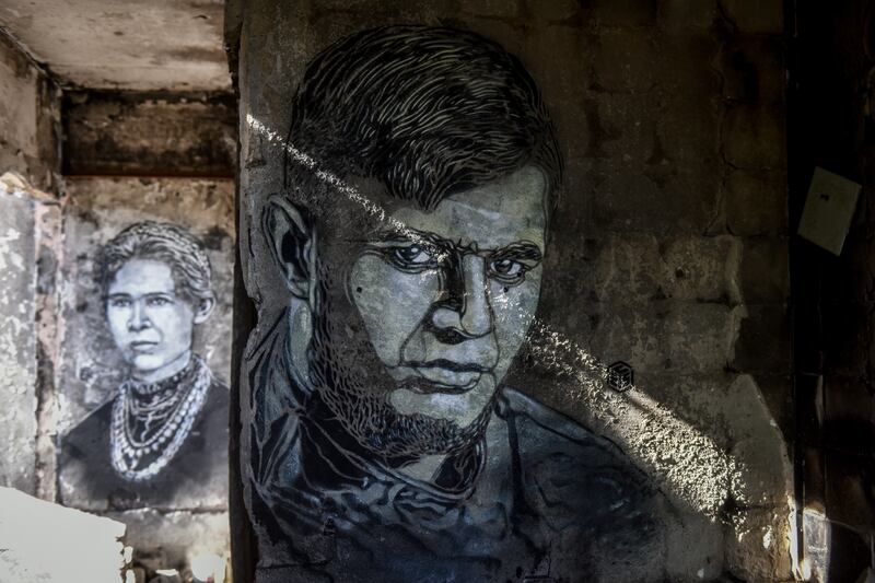 A portrait of Ukrainian serviceman Dmytro Kotsiubailo by street artist Christian Guemy, known as C215, on the wall of a house destroyed by Russian shelling in Borodyanka, Kyiv region. All photos: EPA