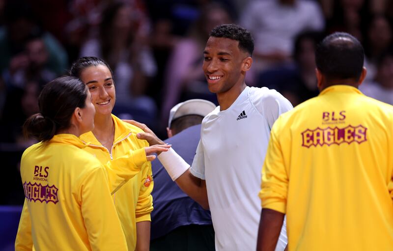 Felix Auger- Aliassime of Kites is congratulated by Caroline Garcia of Eagles and Bianca Andreescu of Eagles after winning his men's singles match against Nick Kyrgios of Eagles. Getty 