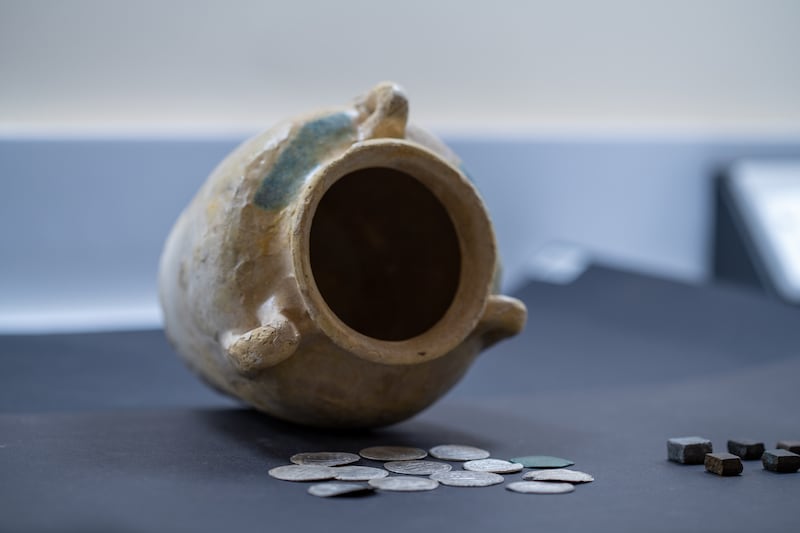 A haul of ancient coins from the Abbasid dynasty was discovered in this ancient pot by a team from Sharjah Archaeology Authority. Photo: Wam