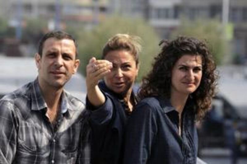 Nehjar Isler, left, the producer Nida Karabol Akdeniz, centre, and the director Pelin Esmer, right of the film 10 to 11, which plays at the Middle East International Film Festival.