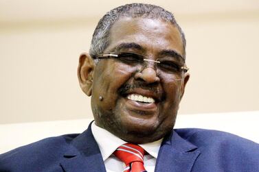 Mohamed Tahir Ela smiles after being sworn in as prime minister during a ceremony of new officials after President Omar Al Bashir dissolved the central and state governments in Khartoum. Reuters 