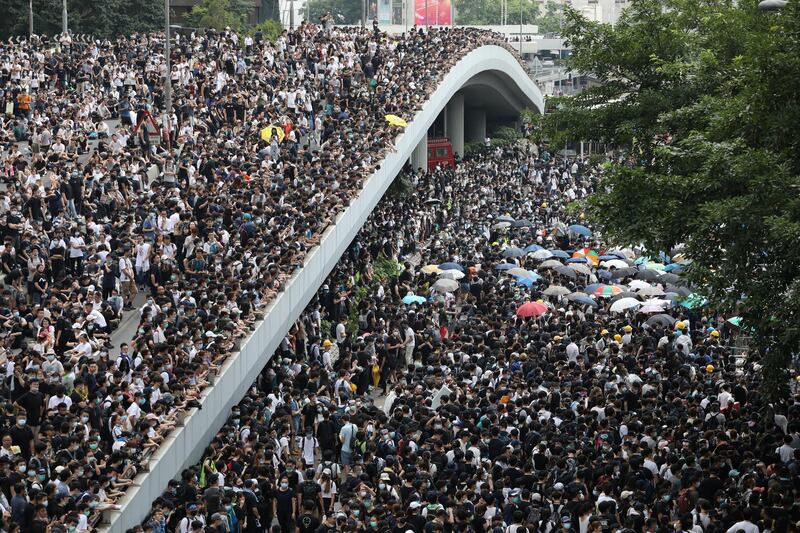 Protesters march along a road demonstrating against a proposed extradition bill in Hong Kong, China. Reuters