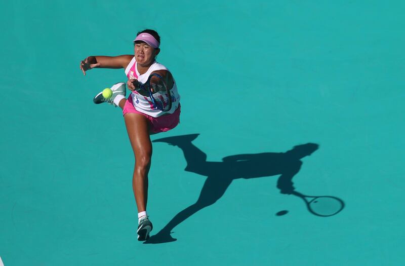 Xiyu Wang of China in action against Arantxa Rus of The Netherlands during their Women's Singles match on Day Two of the Abu Dhabi WTA Women's Tennis Open. Getty Images