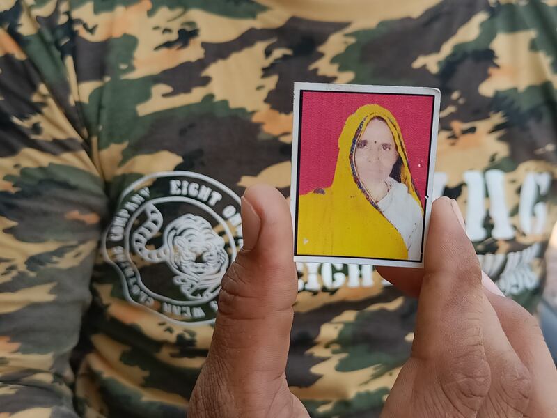 Rajesh Kumar Yogi, 30, showing his mother Jamuna Devi’s picture. She was attacked and mauled to death by a tiger near her fields in Sawai Madhopur in Rajasthan in February 2019. Taniya Dutta / The National