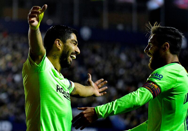 Luis Suarez celebrates a goal with Lionel Messi. AFP