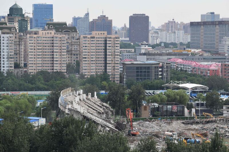 Workers demolish one of the last remaining sections of grandstand. AFP
