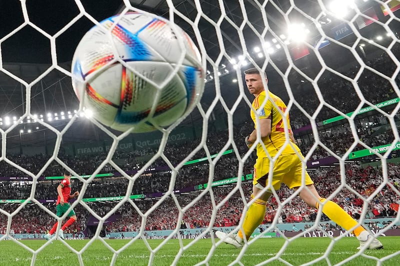 Spain's goalkeeper Unai Simon watches Morocco's Achraf Hakimi's winning penalty hits the back of the net. AP 