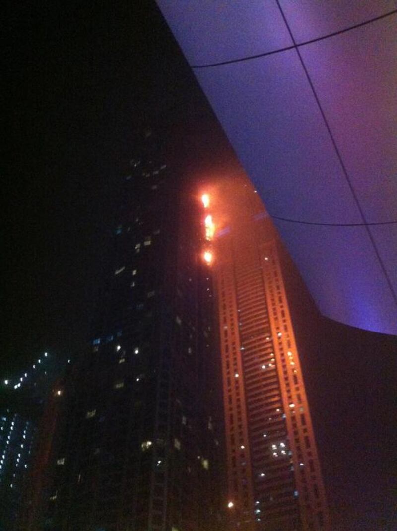 An iPhone picture of the Torch tower in the Marina on fire. Image supplied by a bystander.