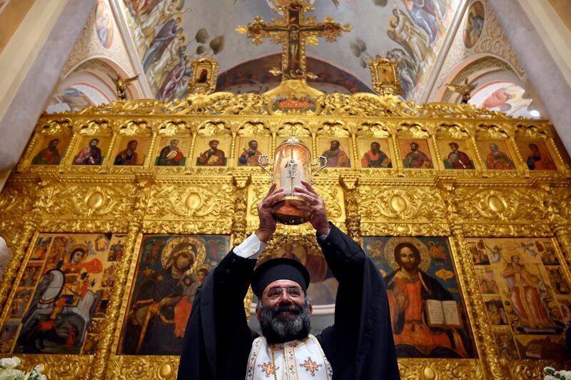 A Greek Orthodox priest in Beirut carries the Holy Fire as he arrives at Saint George Greek Orthodox Cathedral from Jerusalem via Amman. Orthodox Christian believers use Holy Week to mark the crucifixion and resurrection of Jesus Christ. The Eastern Orthodox world celebrates Easter according to the old Julian calendar. EPA