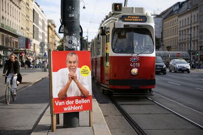 A poster telling Austrians to 'vote Van der Bellen' hangs next to a tram line in Vienna. AP 