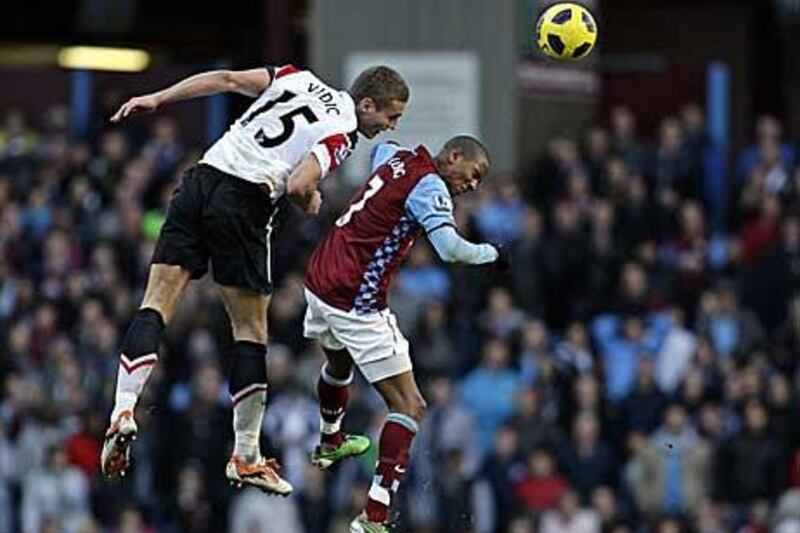 Nemanja Vidic, the Manchester United captain, beats Aston Villa’s Ashley Young to a header.
