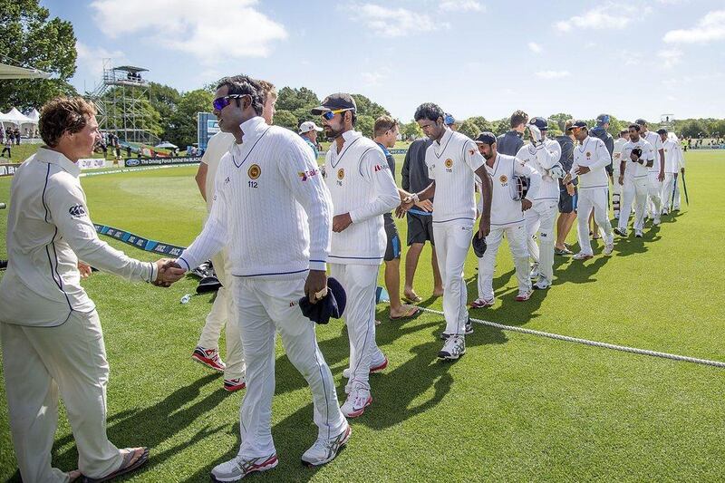 Sri Lanka's Angelo Mathews, right, shakes hands with New Zealand after his side lost the first Test on December 29, 2014. Marty Meville / AFP