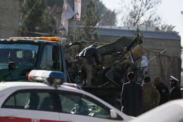 Afghan security personnel clear wreckage from a car bomb explosion in Kabul on December 31, 2020. AP Photo
