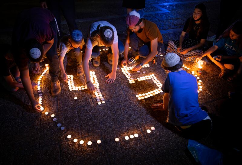 Young Israelis light candles in memory of the 45 ultra-Orthodox Jews killed in a stampede at a religious festival last year, during a vigil in Tel Aviv, Israel. Police at Mt Meron were expecting the arrival of thousands of mostly ultra-Orthodox worshippers and revellers on Wednesday, May 18, 2022, a year after the fatal stampede. AP Photo