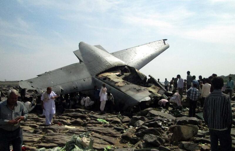 Onlookers surround a C-130J Hercules cargo plane which crashed on the outskirts of Gwalior city in central Madhya Pradesh state. A new C-130J Hercules cargo plane on a training mission crashed in central India killing all five crew members, an Air Force spokesman said, the latest in a string of military accidents.  AFP / March 28, 2014