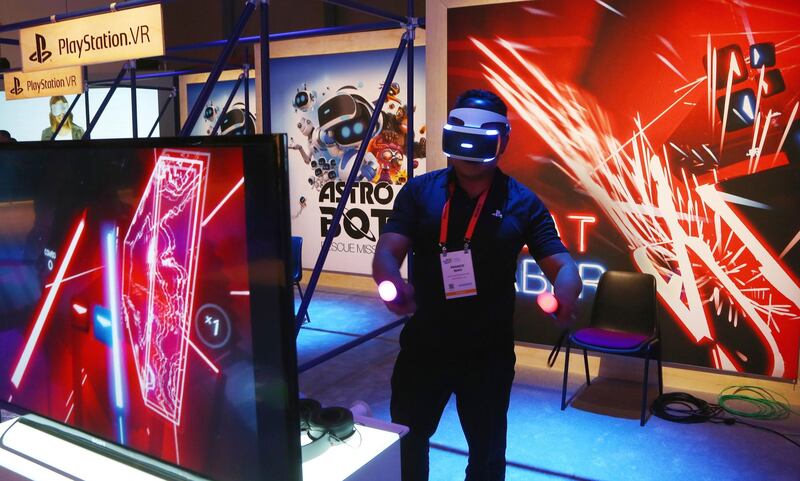 An attendee plays the PlayStation VR Beat Saber game. AP Photo