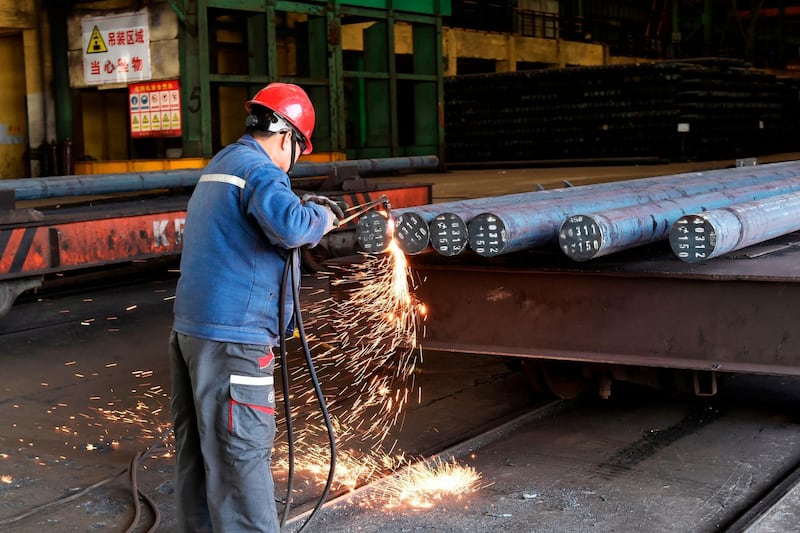 A worker cuts steel at a factory in Zouping in China's eastern Shandong province on April 9, 2018. 
China said on April 6 it is ready to pay "any cost" in a trade war after US President Donald Trump threatened an additional 100 billion USD in tit-for-tat tariffs on Beijing. / AFP PHOTO / - / China OUT