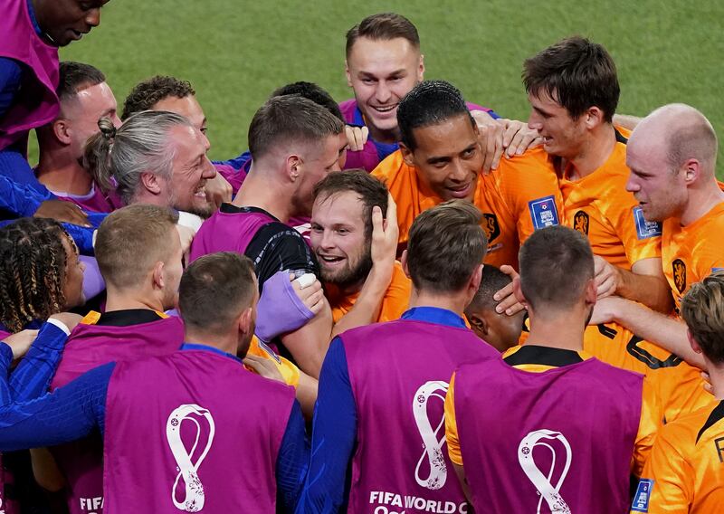 Netherlands' Daley Blind is mobbed by teammates after scoring the second goal. PA