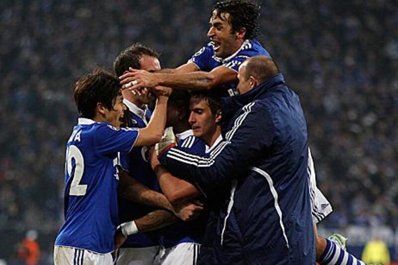 Schalke players celebrate after securing their passage into the Champions League quarter-finals after a 4-2 aggregate win against Valencia.