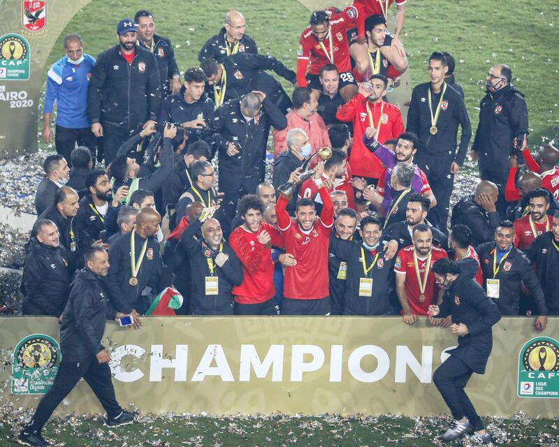 Ahly's players celebrate with the trophy after winning the CAF Champions League Final football match between Egyptian sides Zamalek and Al-Ahly at the Cairo International Stadium in Egypt's capital on November 27, 2020. (Photo by Khaled DESOUKI / AFP)