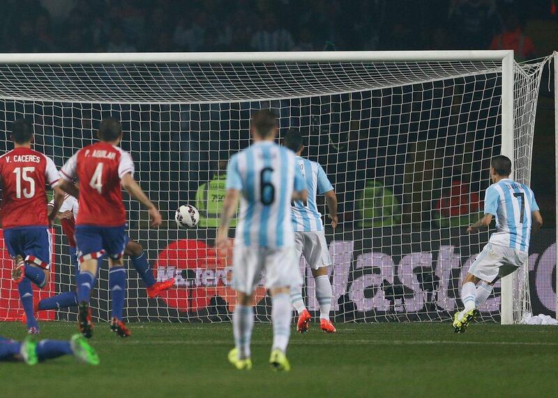 Argentina's Angel Di Maria, right, scores his side’s fourth goal six minutes later to make it 4-1 against Paraguay in the Copa America semi-final on Tuesday night. Andre Penner / AP