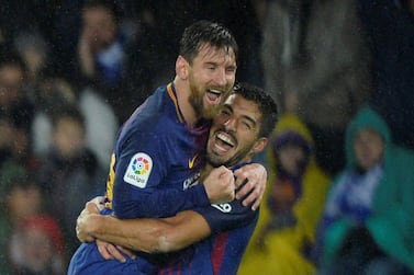 Barcelona’s Lionel Messi celebrates with Luis Suarez after scoring their fourth goal against Real Sociedad. Vincent West / Reuters