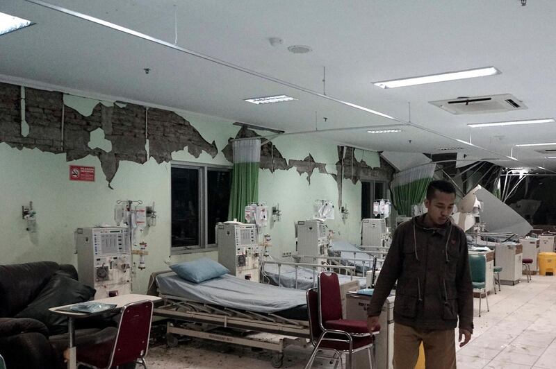 An Indonesian man walks inside a damaged room in the Banyumas regional public hospital in the aftermath of a 6.5 magnitude earthquake in Banyumas, Central Java, Indonesia. Bayi Nur / EPA
