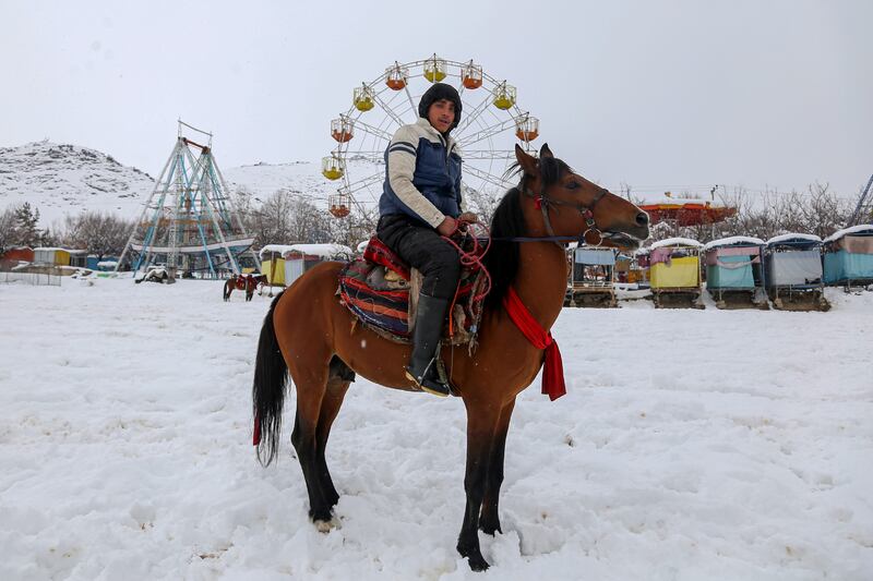 An Afghan horseman rides in the snow in Kabul. EPA