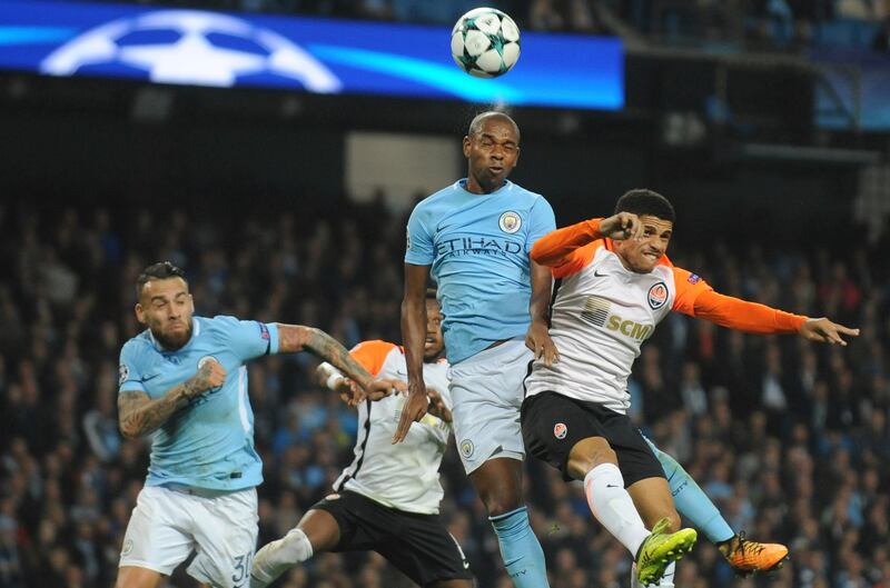 Manchester City's Fernandinho, centre, heads the ball clear as Shakhtar's Taison challenges for the ball. Rui Vieira / AP Photo