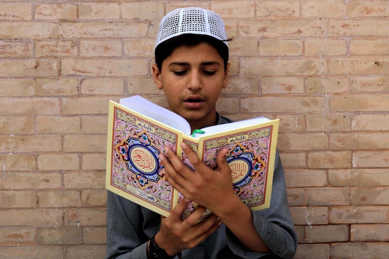 epa08385093 A Pakistani Muslim boy reads verses from the holy Koran at a Mosque during the Muslim holy month of Ramadan amid lockdown of the Khyber Pakhtunkhwa  province due to the ongoing coronavirus COVID-19 disease pandemic, in Peshawar, Pakistan, 26 April 2020. Muslims around the world celebrate the holy month of Ramadan, by praying during the night time and abstaining from eating, drinking, and sexual acts during the period between sunrise and sunset. Ramadan is the ninth month in the Islamic calendar and it is believed that the revelation of the first verse in Koran was during its last 10 nights.  EPA/BILAWAL ARBAB