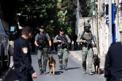 Israeli security personnel patrol with specially trained dogs in Jerusalem. Reuters