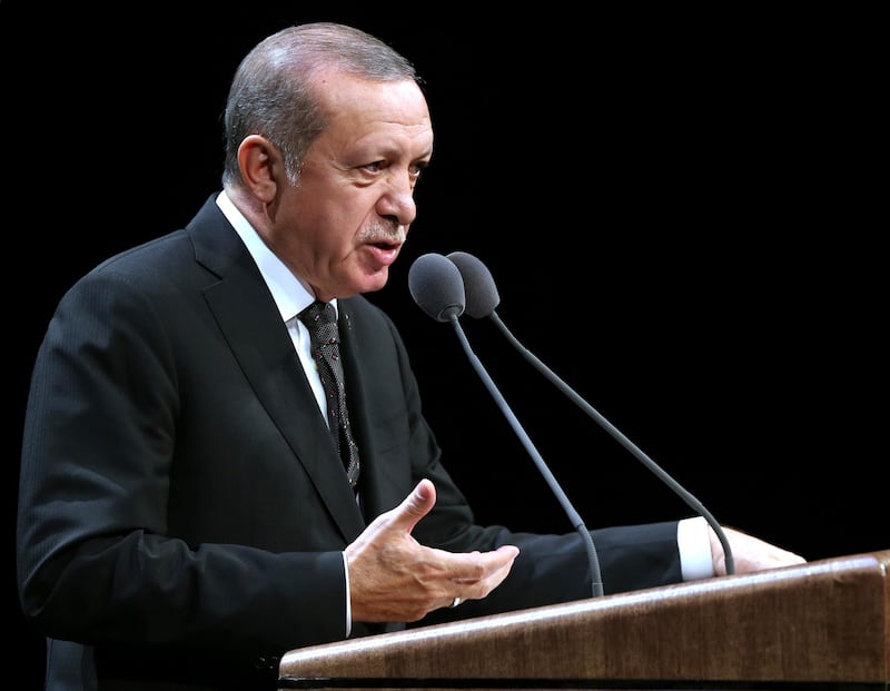 Turkish President Recep Tayyip Erdogan addresses academics at his palace in Ankara, Turkey, Tuesday, Sept. 26, 2017. Erdogan says "attacks" against Turkey by German politicians during their election campaigns has led to an outcome which leaves them unlikely to form a new government for "at least a few months." Erdogan said Tuesday that the Netherlands was similarly not able to form a government because Dutch politicians had "attacked us over and over again." (Pool photo via AP)