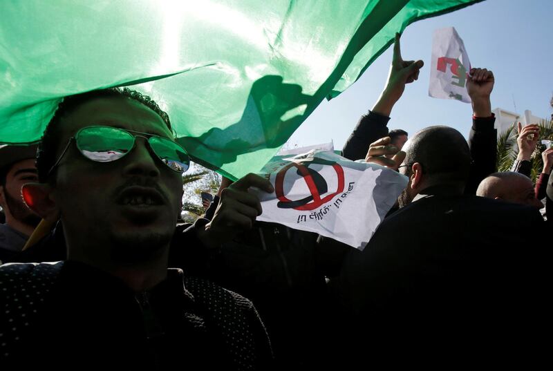 Demonstrators wave flags at a protest against President Abdelaziz Bouteflika's plan to seek a fifth term in Algiers, Algeria, February 22, 2019. Reuters