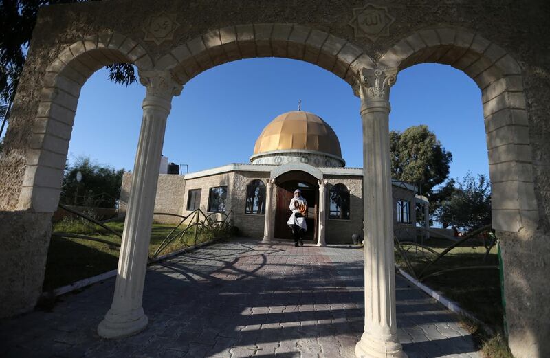 A man he walks in front of a model of the Dome of the Rock in the southern Gaza Strip. Reuters
