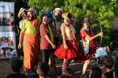 Humanitarian clown Sabine Choucair, second from right, performs in Horsh Beirut. India Stoughton for The National