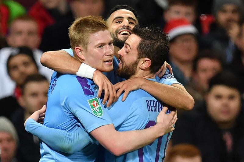 Riyad Mahrez (C) celebrates scoring City's second goal with Kevin De Bruyne and Bernardo Silva. AFP