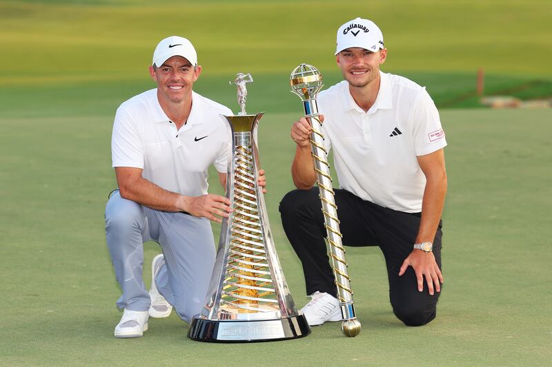 Race to Dubai winner Rory McIlroy and DP World Tour Championship winner Nicolai Hojgaard on the 18th green at the Earth Course at Jumeirah Golf Estates on November 19, 2023. Getty Images