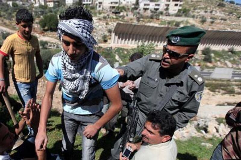 Palestinian protesters argue with Israeli soldiers during a demonstration against Israel's separation barrier in the West Bank village of Beit Jalla earlier this month.