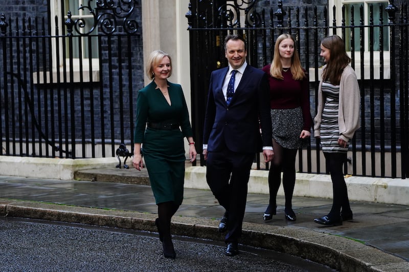 Mr Truss, with her husband Hugh O'Leary and their daughters, leaves Downing Street. PA