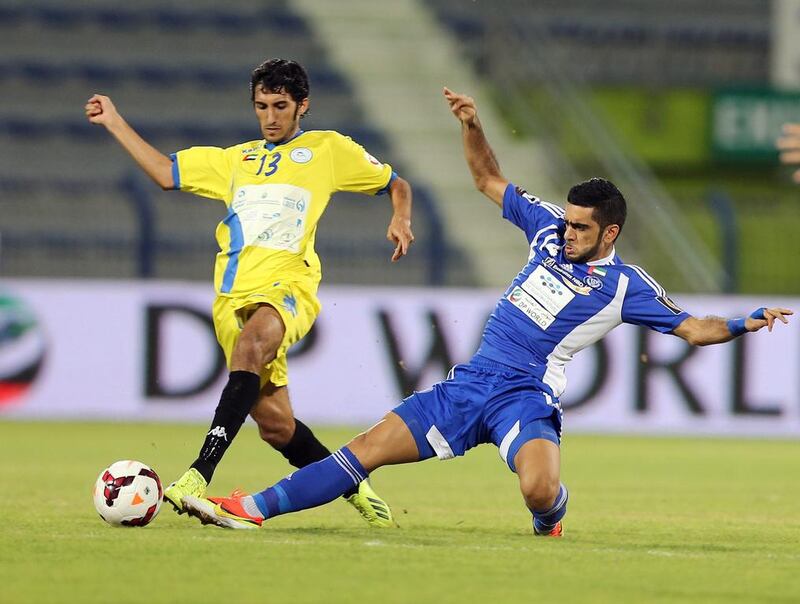 Ali Al Hammadi, left, is challenged by Humaid Ahmed of Al Nasr in Al Dhafra's 2-1 win. Ashraf Al Amra / Al Ittihad