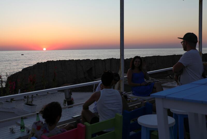 Diners admire the sunset in Batroun. Reuters