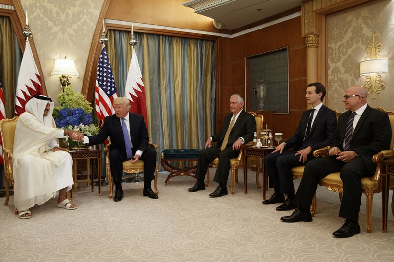 US president Donald Trump, second left, shakes hands with Qatar’s Emir Sheikh Tamim Bin Hamad Al-Thani, left, during a bilateral meeting, on Sunday, May 21, 2017, in Riyadh. Seated with them are: US secretary of state Rex Tillerson, third right, White House senior adviser Jared Kushner, second right, and US national security adviser HR McMaster. Evan Vucci / AP Photo