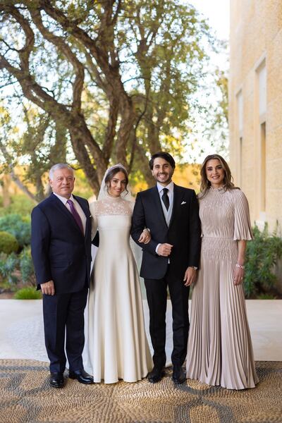 King Abdullah II and Queen Rania of Jordan with their daughter Princess Iman and Jameel Alexander Thermiotis on their wedding day. Both Queen Rania and Princess Iman wear Dior. AFP