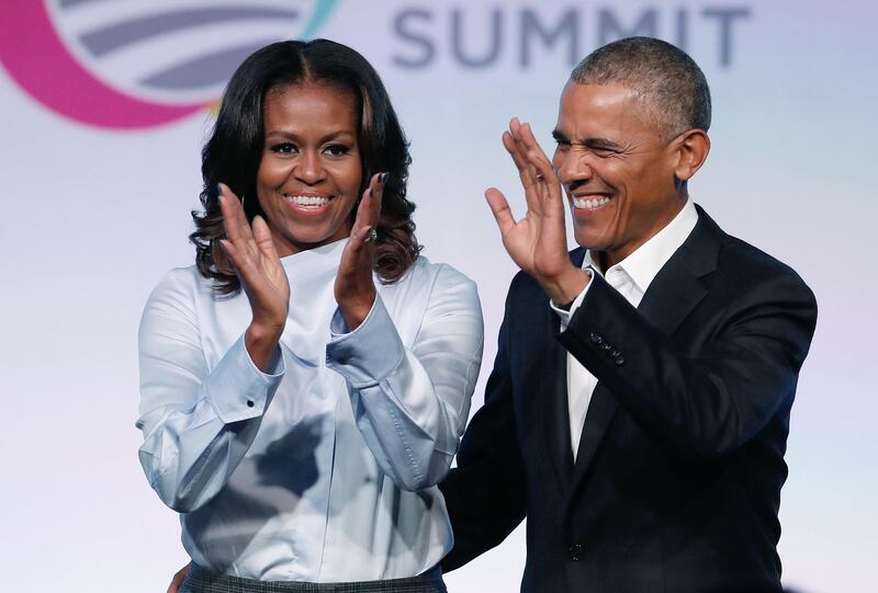 (FILES) In this file photo taken on October 31, 2017, former US President Barack Obama and First Lady Michelle Obama arrive at the Obama Foundation Summit in Chicago, Illinois. Barack and Michelle Obama have entered into a multi-year agreement to produce films and series with Netflix, the world's leading internet entertainment service announced on May 21, 2018. The former first couple have launched Higher Ground Productions to produce a variety of content for the video streamer, possibly including scripted series, documentaries and features.
 / AFP / Jim Young
