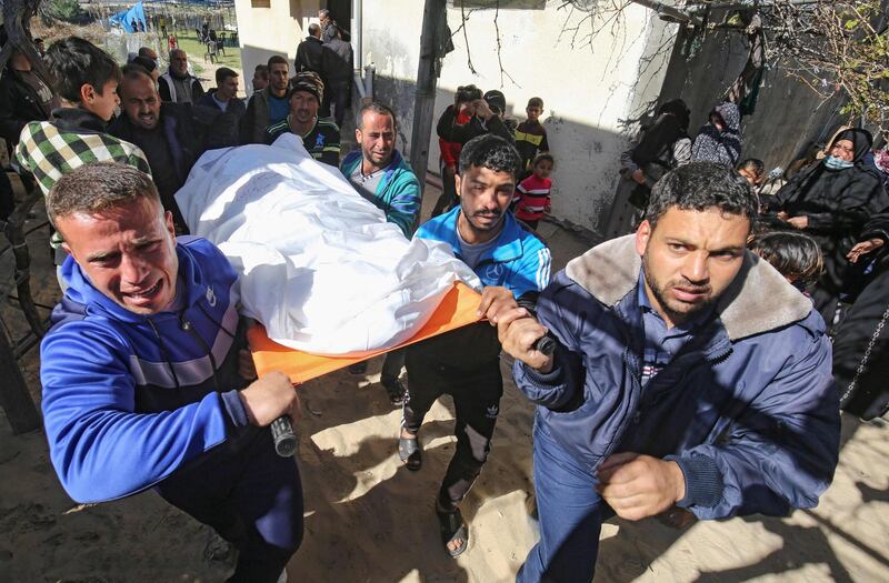 Mourners carry the body of one of the three Palestinian fishermen, who were killed when their boat exploded off Gaza's coast in the Mediterranean Sea, during their funeral in Khan Yunis in the southern Gaza Strip. AFP